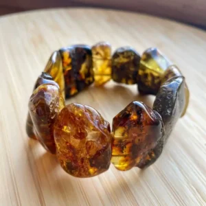 Stunning amber bead bracelet showcasing unique gemstones in warm golden and reddish hues.