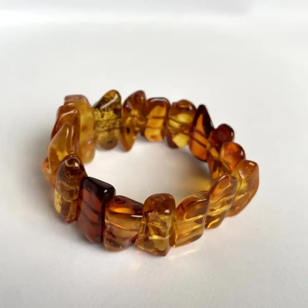 Stylish amber bracelet featuring polished beads with natural inclusions and warm golden hues.