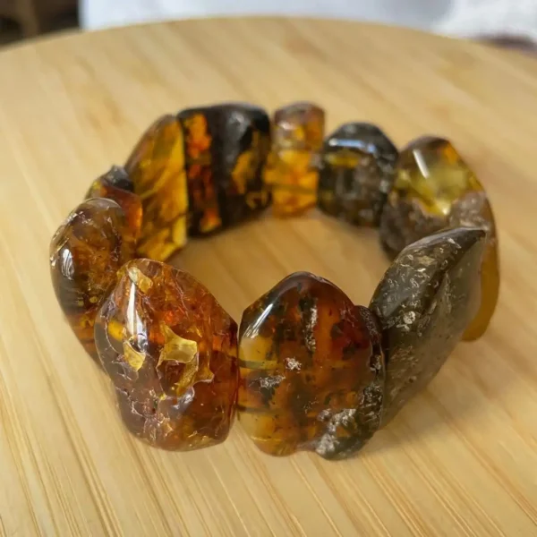 Handcrafted amber bracelet featuring uniquely shaped stones in rich, warm hues.