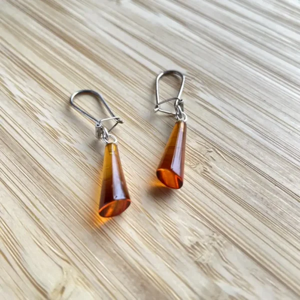 Elegant amber cone drop earrings, showcasing artisan craftsmanship and warm hues.