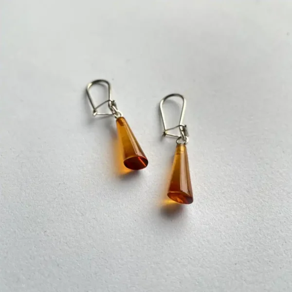 Stylish amber cone earrings with minimalist design and metal earhooks, perfect for any occasion.