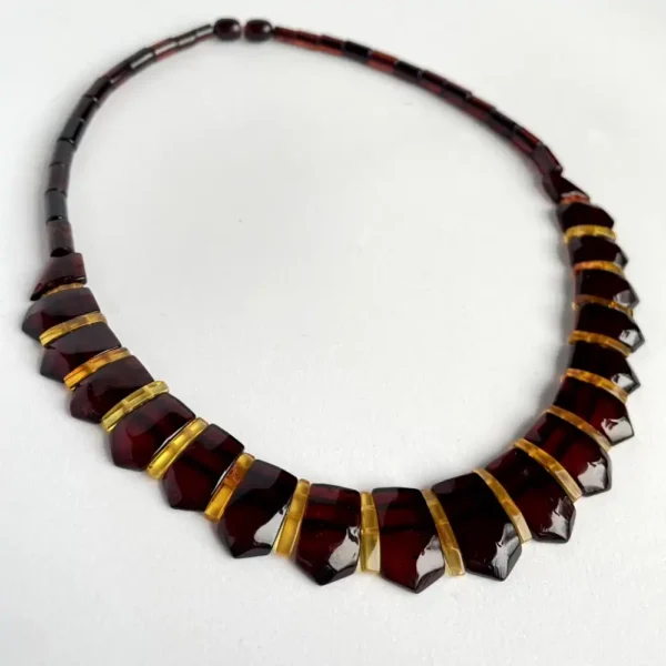 Elegant amber gemstone necklace with contrasting yellow-orange spacers for a sophisticated look.