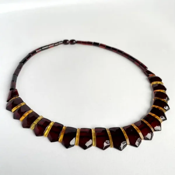 Elegant amber garnet bead necklace with golden spacers, perfect for any occasion.