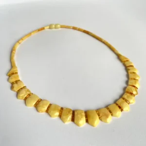 Elegant soft yellow ambernecklace with unique crafted beads, perfect for any occasion.