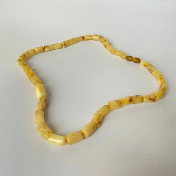 Elegant amber bead necklace with handcrafted design, featuring warm, golden-yellow hues for unique style.