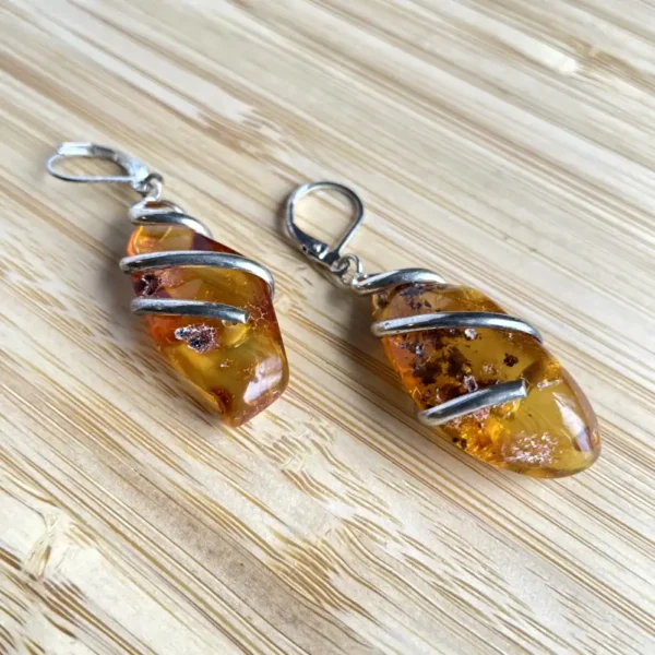 Elegant teardrop amber earrings, showcasing unique natural beauty and craftsmanship.