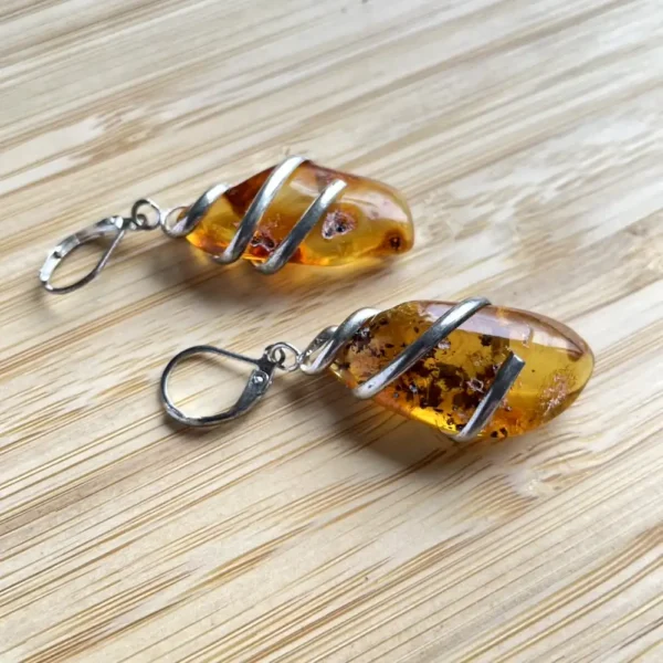 Elegant amber earrings, showcasing natural inclusions and a polished finish.