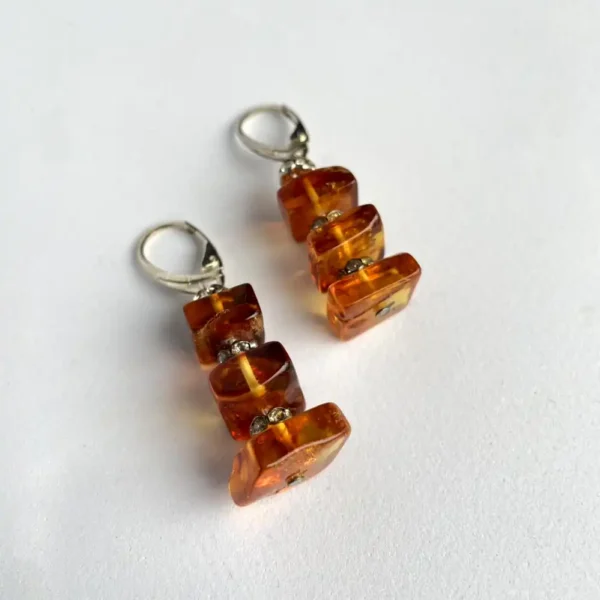 Elegant amber lever-back earrings showcasing modern design and natural beauty.