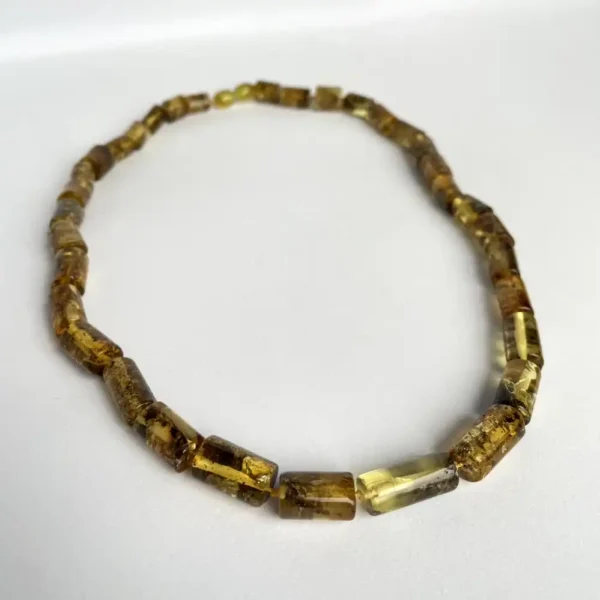 Elegant amber necklace with unique rectangular beads showcasing natural hues and textures.