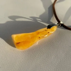 Elegant amber pendant, showcasing natural inclusions and rich golden-yellow hues.