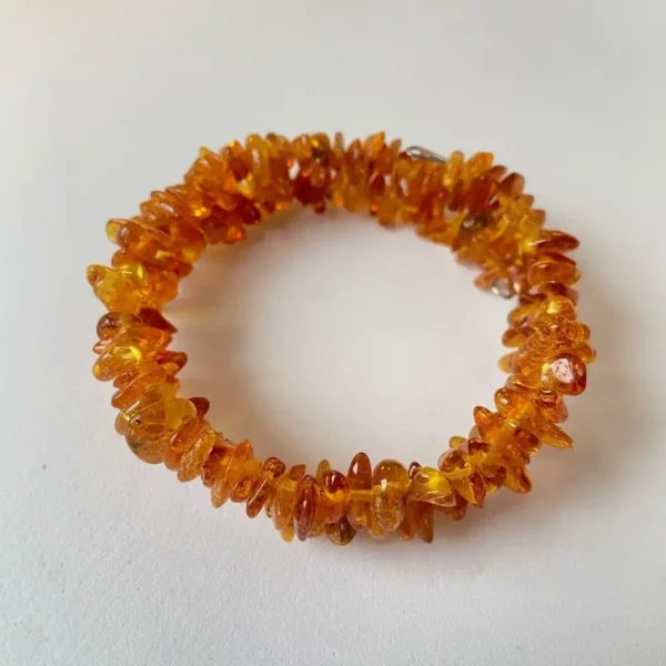 Vibrant amber teardrop bracelet showcasing natural beads with earthy elegance and unique inclusions.