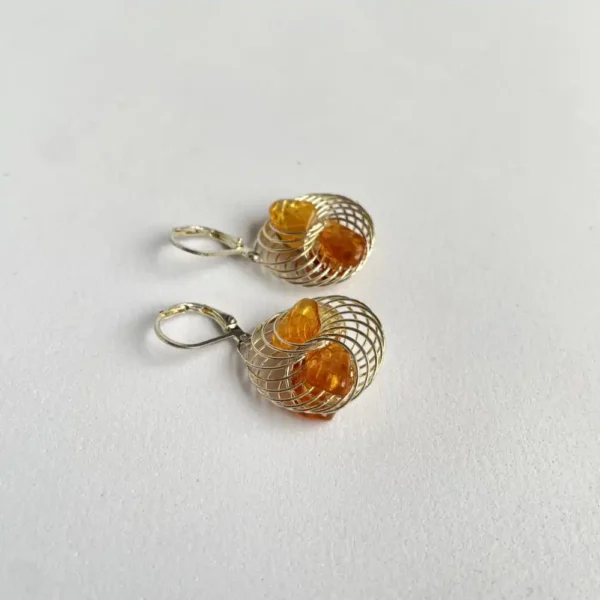 Elegant wire earrings with amber gemstones, showcasing a stunning blend of contemporary and natural design.