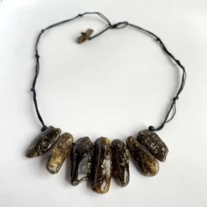 Handmade polished amber stone necklace featuring earthy tones and unique natural stone beads.