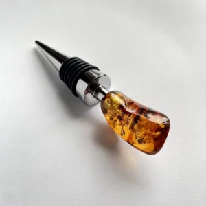 Elegant amber wine stopper with polished metal shaft and rubber rings for airtight seal.