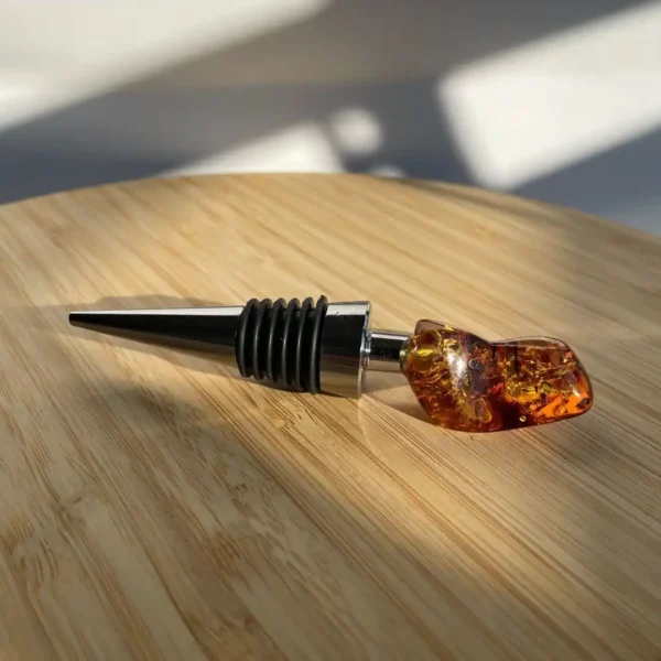 Elegant wine stopper with amber top on a wooden surface, perfect for preserving fine wine.