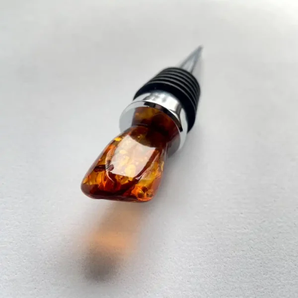 Beautiful amber wine stopper with sleek metallic accents, perfect for elegant table settings.