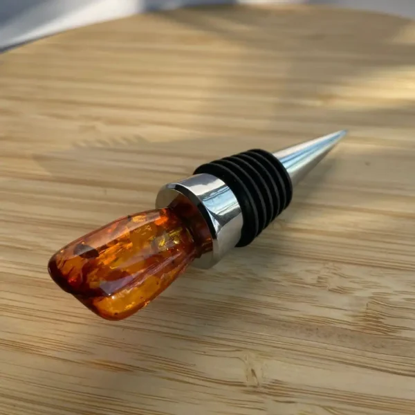 Elegant wine stopper with amber resin and stainless steel design for stylish preservation.