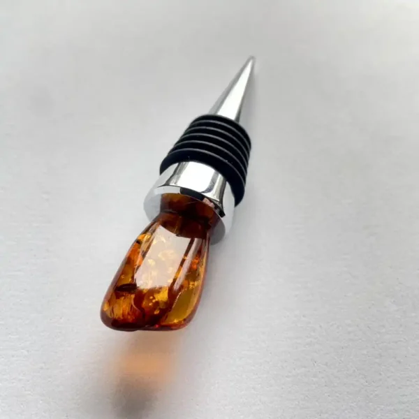 Elegant amber wine stopper with chrome accents, perfect for sealing and enhancing wine bottles.