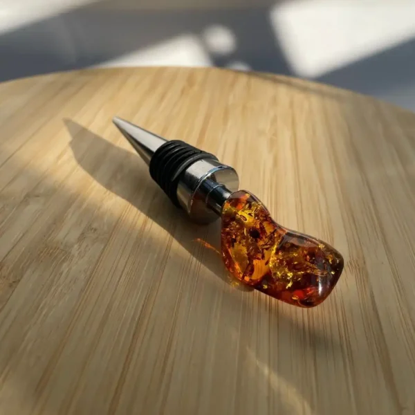 Elegant amber and metal wine stopper for preserving freshness and enhancing your home bar decor.