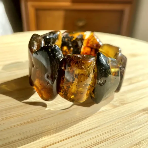 Elegant amber bracelet showcasing polished pieces with warm hues and unique natural inclusions.