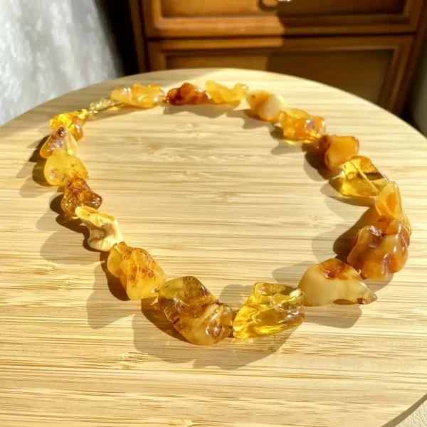 Elegant amber necklace on a wooden surface, showcasing natural beauty and unique craftsmanship.