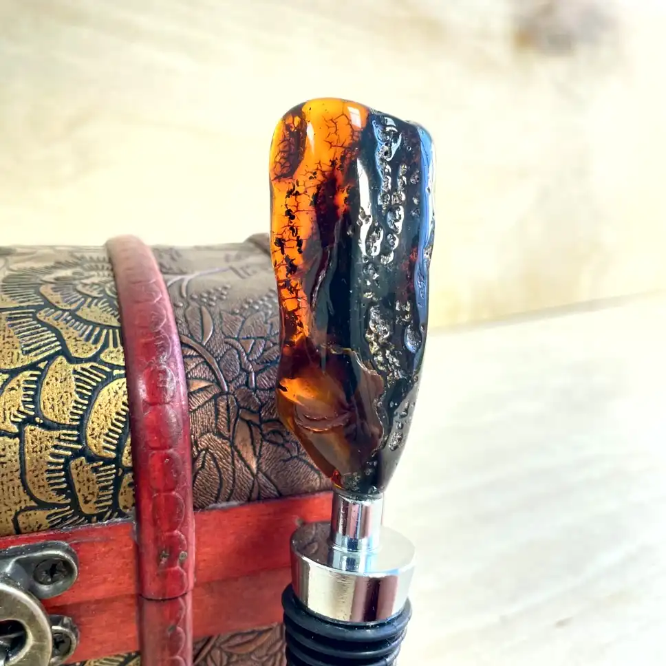 Elegant amber bottle stopper in a decorative wooden box, showcasing artisanal craftsmanship.
