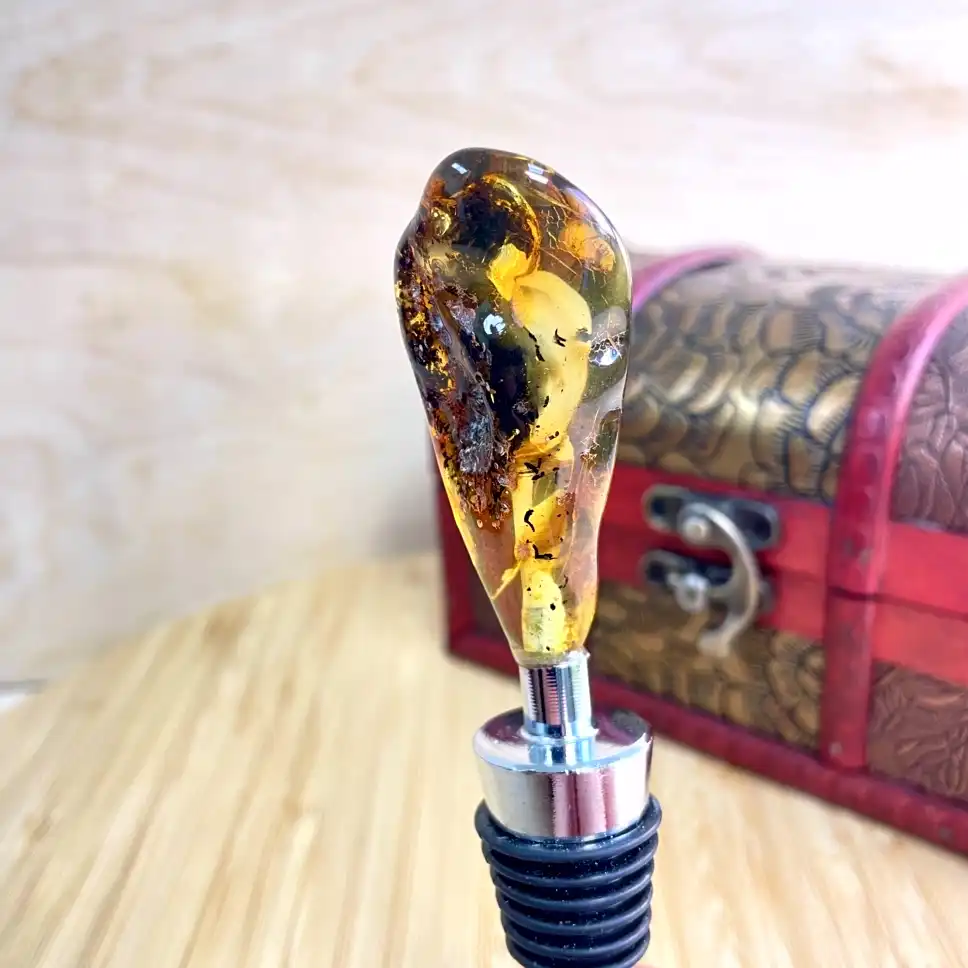 Elegant amber bottle stopper showcasing natural inclusions, perfect for enhancing any wine collection.