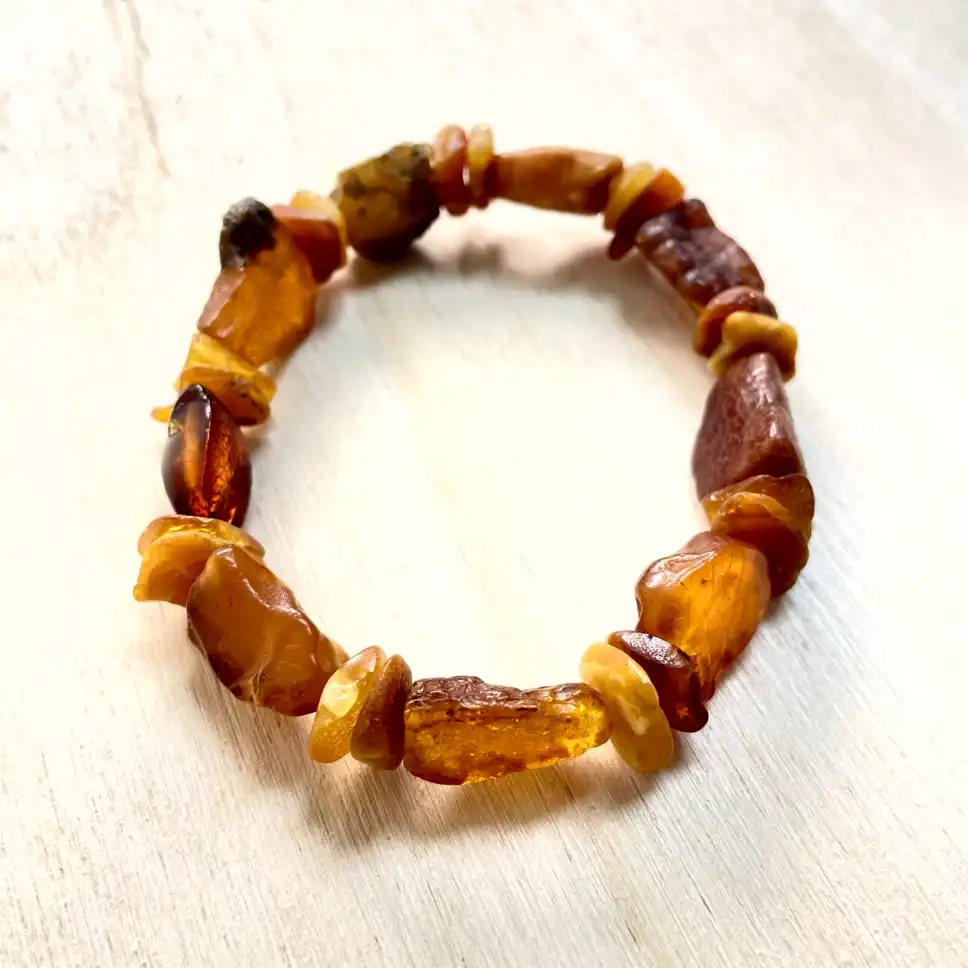 Stunning amber nugget bracelet with unique beads, showcasing natural hues of orange and yellow.