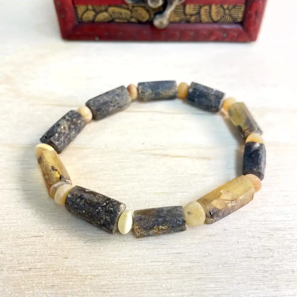 Elegant amber bead bracelet with natural stones, featuring earthy tones and handcrafted design for everyday wear.