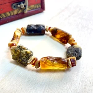 Stunning amber nugget bracelet with natural stones, showcasing unique colors and textures in a circular design.