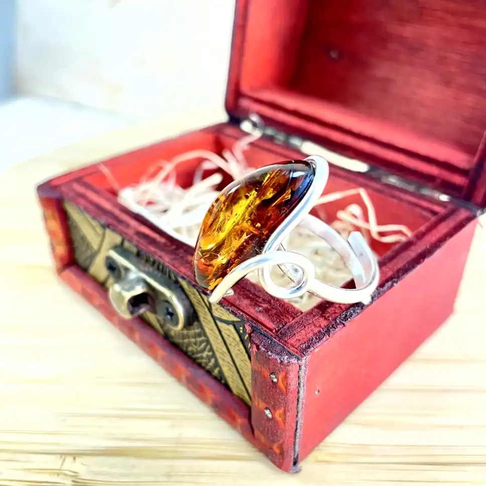 Stunning silver-plated amber bracelet in vintage red box, showcasing elegant design and natural beauty.