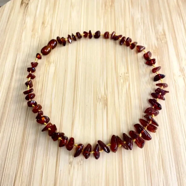 Elegant circular amber necklace showcasing varied bead sizes and warm hues.