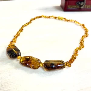 Elegant Amber Necklace with Medium Stones featuring polished beads in warm hues, perfect for any occasion.