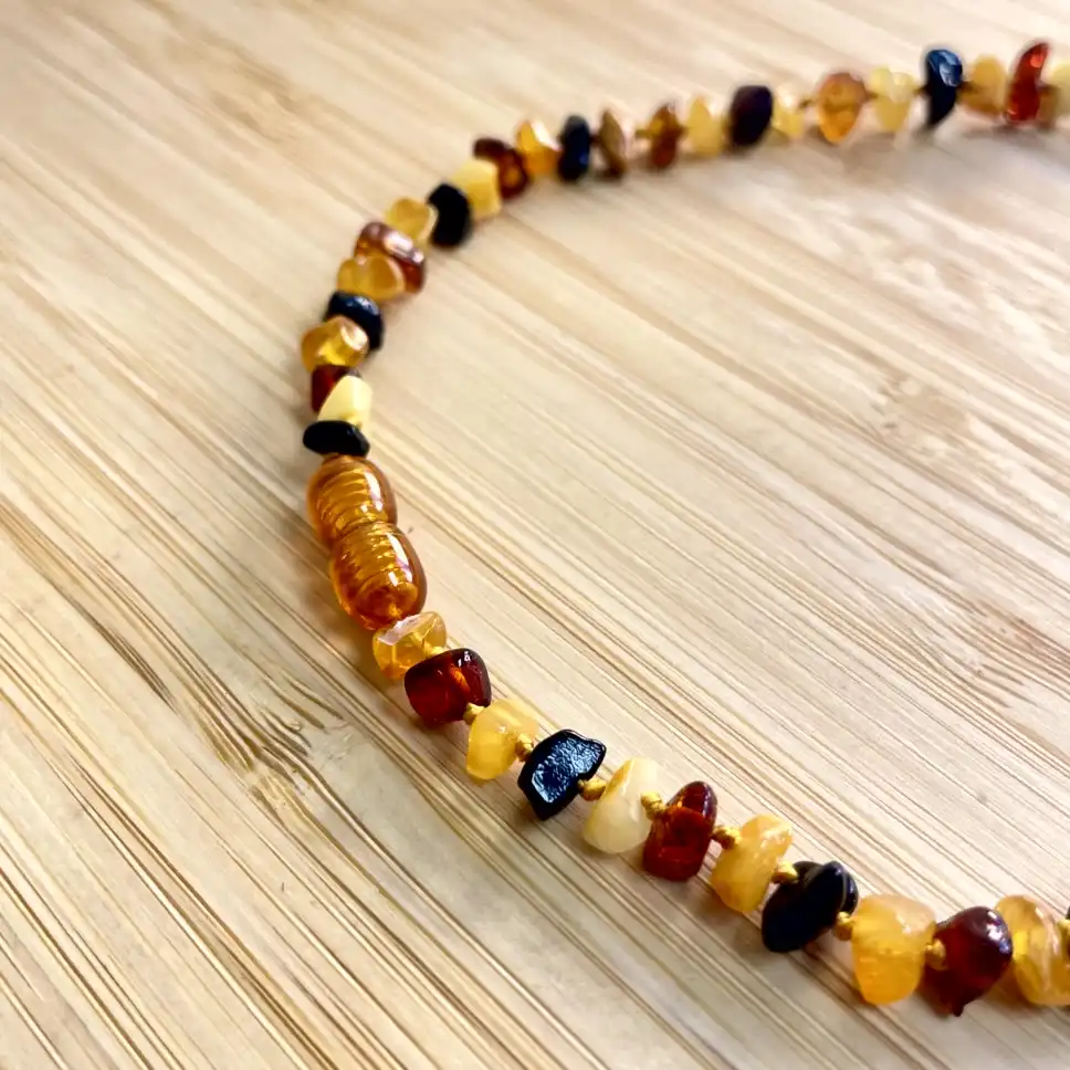 Elegant amber teething necklace featuring natural beads in rich hues and textures for timeless style.