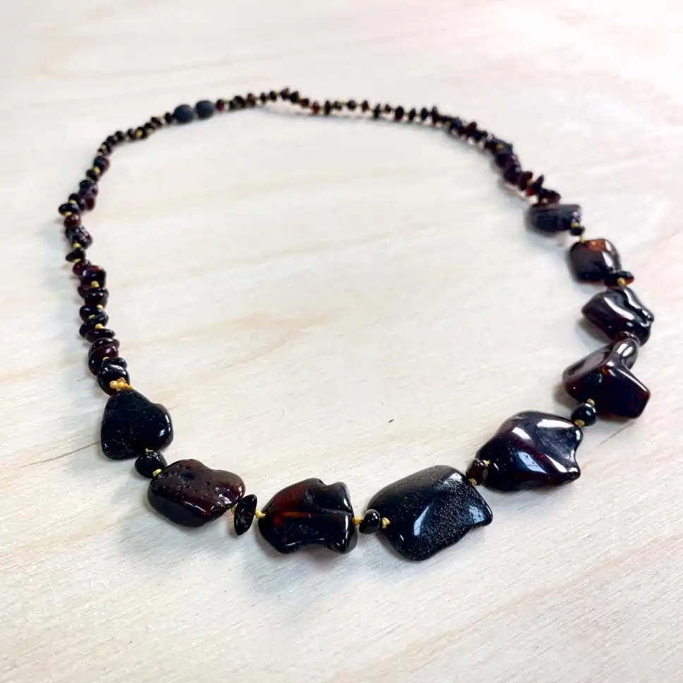 Elegant amber necklace with large stones with natural stones, showcasing unique craftsmanship and earthy tones.
