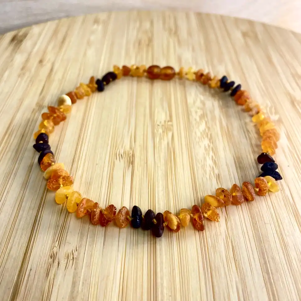 Elegant amber teething necklace with natural beads showcasing warm hues and unique shapes.