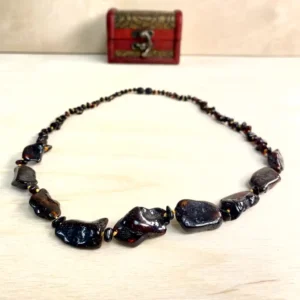 Unique amber necklace with large stones showcasing natural stones and elegant craftsmanship in a decorative box.