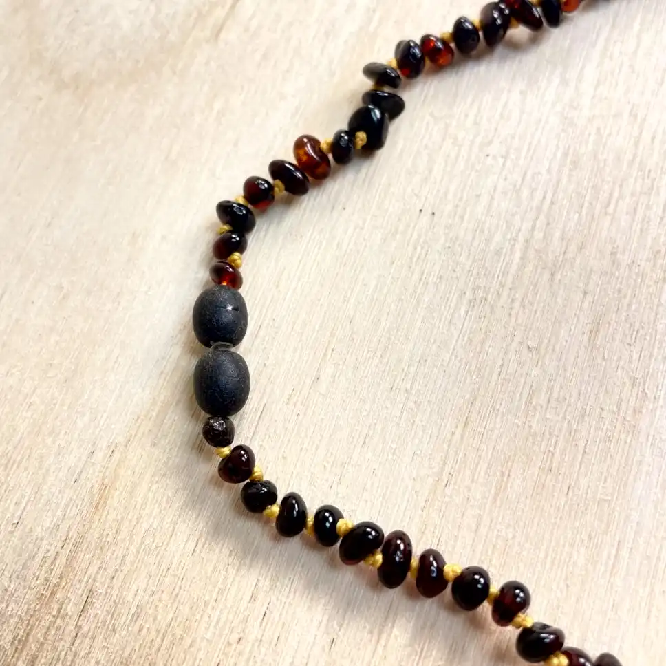 Elegant amber necklace with large stones featuring dark beads, showcasing natural beauty and artisanal craftsmanship.