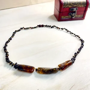 Stunning Amber Necklace with Medium Stones displayed with a decorative red box on a wooden surface.