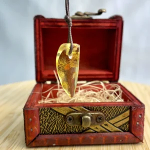 Elegant amber pendant in a rustic wooden box, showcasing natural beauty and intricate details.
