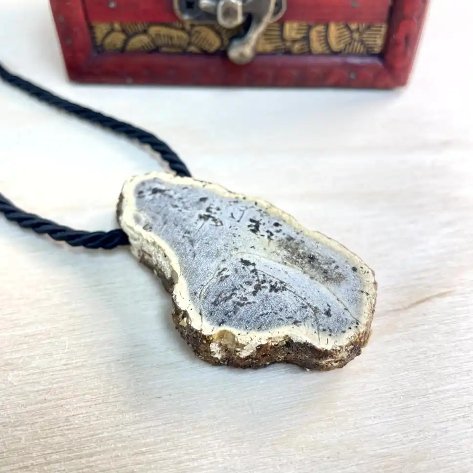 Stunning amber chunk necklace with gold trim, showcasing natural stone beauty and stylish black cord.