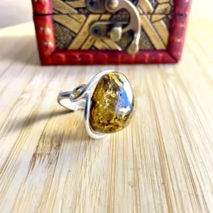 Stunning silver-plated amber ring with silver-plated band, showcasing natural inclusions and exquisite craftsmanship.