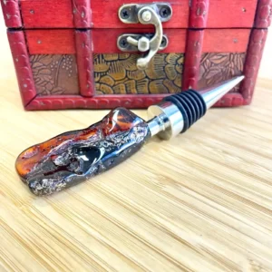 Elegant amber bottle stopper with resin design and stainless steel base in decorative box.