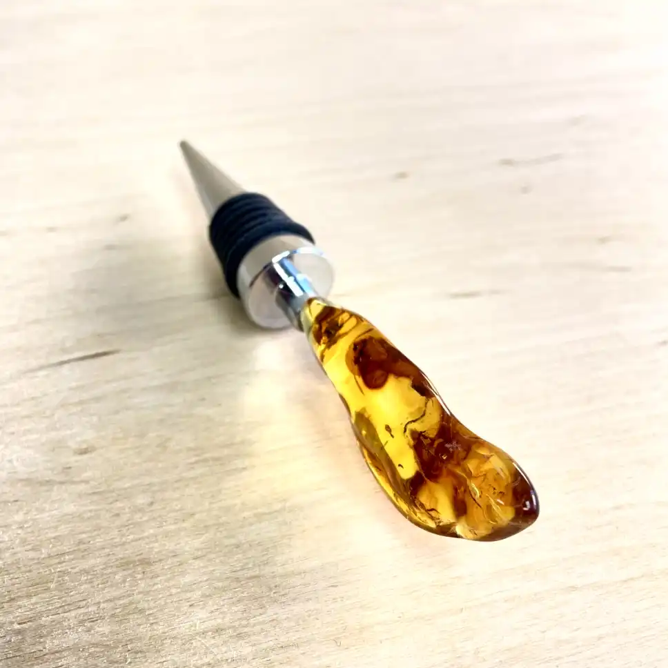 Elegant amber bottle stopper with stainless steel base, perfect for preserving wine freshness.
