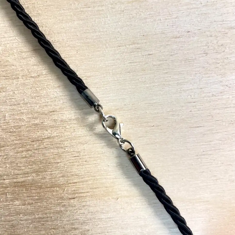 Elegant black braided cord with silver-plated clasp, perfect for handmade amber accessories.