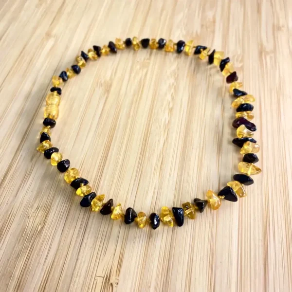 Elegant amber and dark brown bead necklace, perfect natural accessory for any outfit.