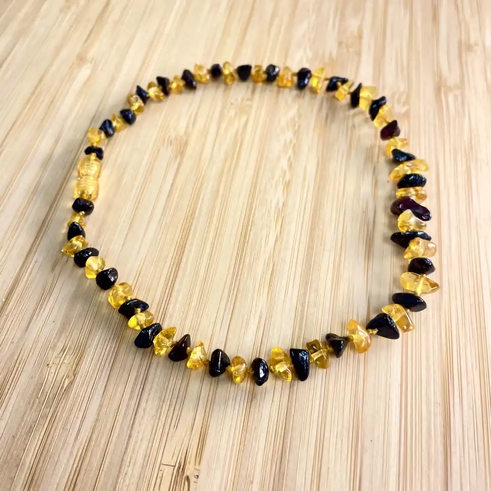 Elegant amber and dark brown bead necklace, perfect natural accessory for any outfit.