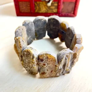 Handcrafted Amber Bracelet with Large Stones with unique textures and colors, beautifully displayed in a decorative box.