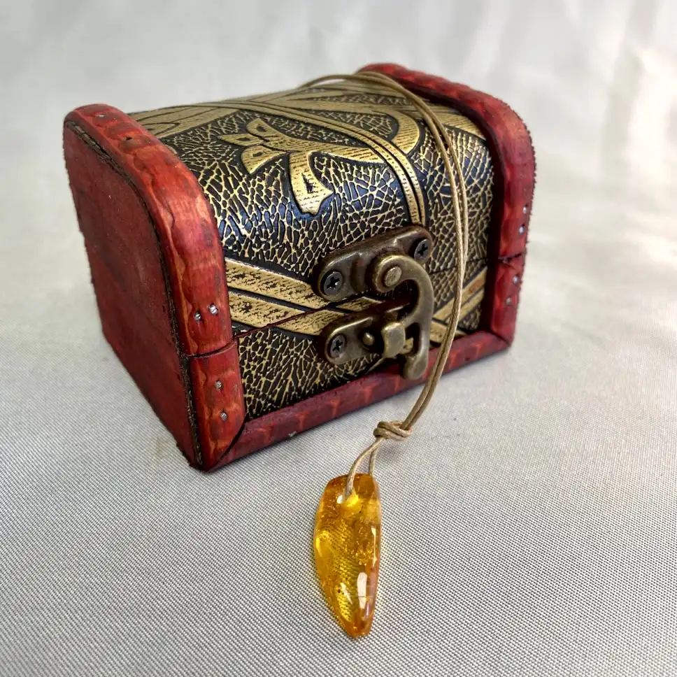 Elegant treasure chest in black and gold with red accents, perfect for decor and adventure.