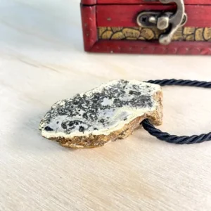 Elegant natural amber amber chunk necklace on a wooden surface, showcasing unique textures and rich colors.